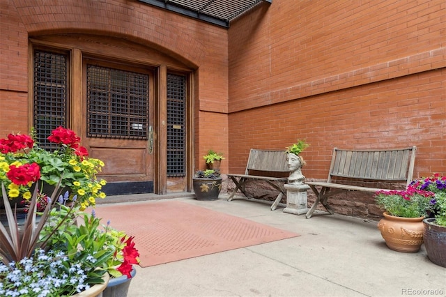 836 E 17th Ave Unit 1A, Denver, CO 80218 - doorway to property featuring a patio area and brick siding