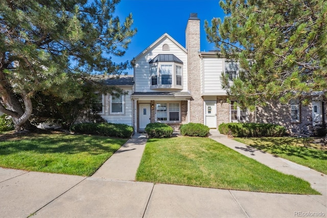 3094 W 107th Pl Unit B, Westminster, CO 80031 - view of property featuring a front yard and a chimney