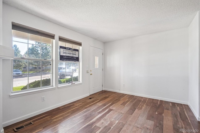 3094 W 107th Pl Unit B, Westminster, CO 80031 - foyer with hardwood / wood-style flooring and a textured ceiling
