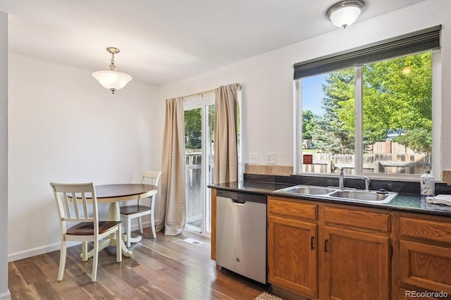 3094 W 107th Pl Unit B, Westminster, CO 80031 - kitchen with stainless steel dishwasher, wood finished floors, dark countertops, and brown cabinets
