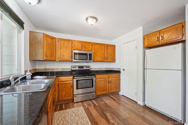 3094 W 107th Pl Unit B, Westminster, CO 80031 - kitchen with stainless steel appliances, dark wood-style floors, and brown cabinetry