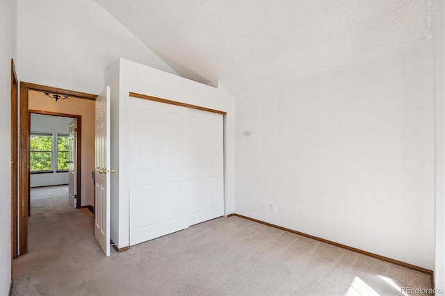 3094 W 107th Pl Unit B, Westminster, CO 80031 - unfurnished bedroom featuring light carpet, vaulted ceiling, and a closet