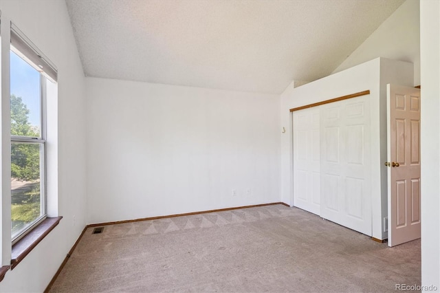 3094 W 107th Pl Unit B, Westminster, CO 80031 - unfurnished bedroom with vaulted ceiling, carpet flooring, multiple windows, and a closet
