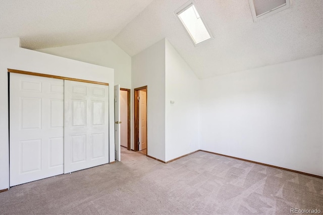 3094 W 107th Pl Unit B, Westminster, CO 80031 - unfurnished bedroom featuring a skylight, carpet floors, lofted ceiling, and a closet