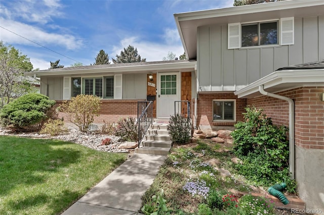 6211 S Garfield Dr, Centennial, CO 80121 - view of front of house featuring brick siding, board and batten siding, and a front yard