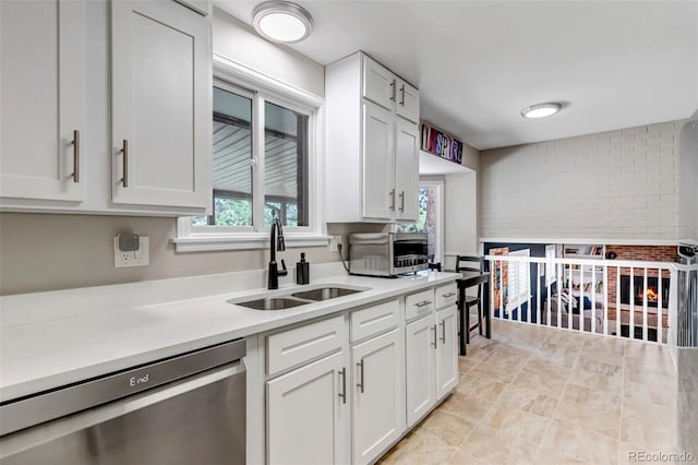 6211 S Garfield Dr, Centennial, CO 80121 - kitchen featuring stainless steel dishwasher, a sink, light countertops, and white cabinets
