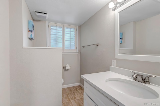 6211 S Garfield Dr, Centennial, CO 80121 - bathroom with vanity, toilet, and baseboards