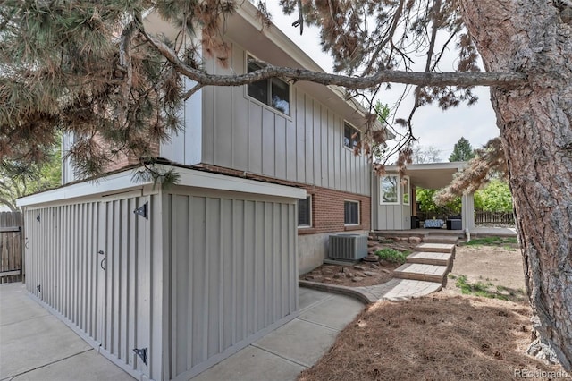 6211 S Garfield Dr, Centennial, CO 80121 - view of home's exterior featuring board and batten siding, brick siding, and central AC