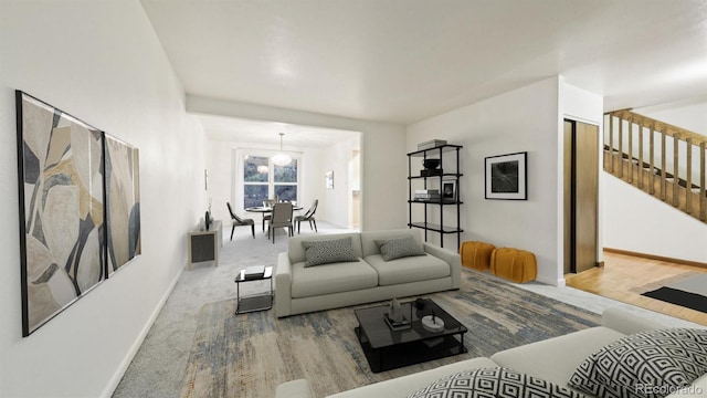 carpeted living room featuring a notable chandelier