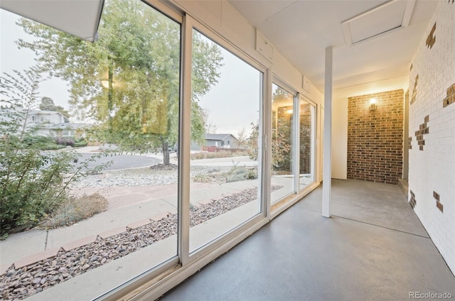 doorway to outside featuring brick wall