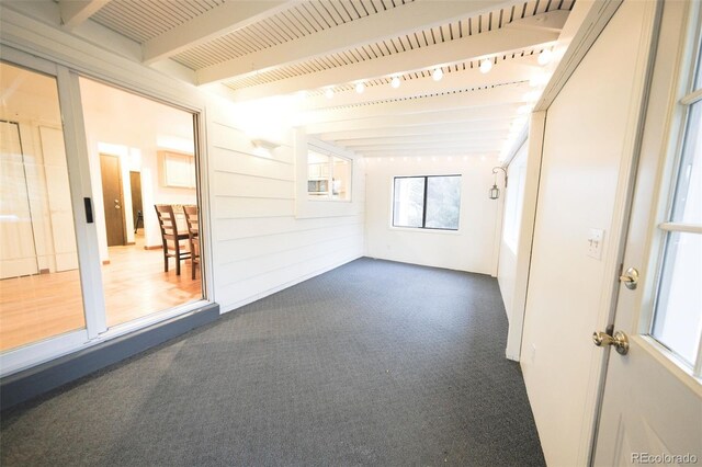 spare room with beamed ceiling and carpet floors