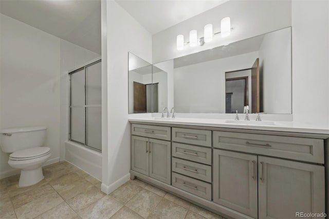 full bathroom with vanity, toilet, and bath / shower combo with glass door