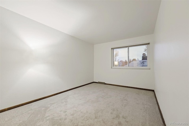 unfurnished room with light carpet