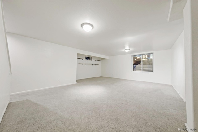 spare room featuring light colored carpet