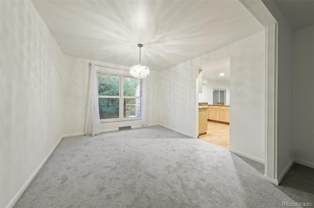 spare room with light colored carpet