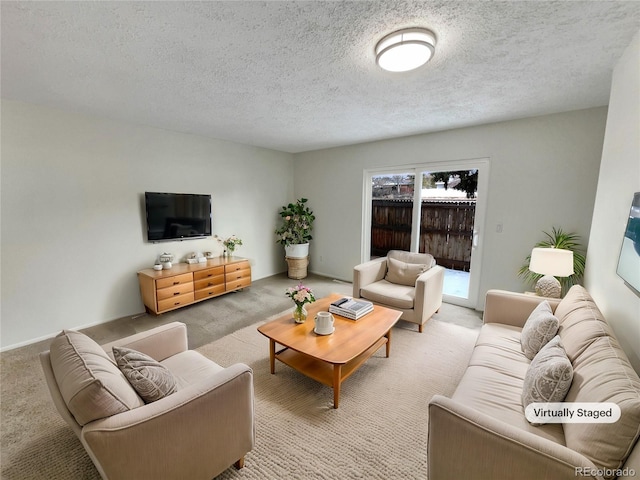 carpeted living room featuring a textured ceiling