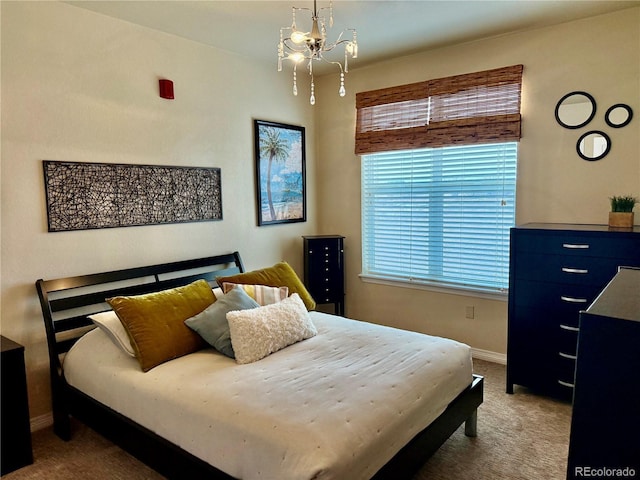 bedroom with carpet floors, an inviting chandelier, and baseboards