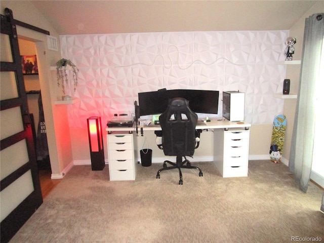 office with light carpet, a barn door, visible vents, and lofted ceiling