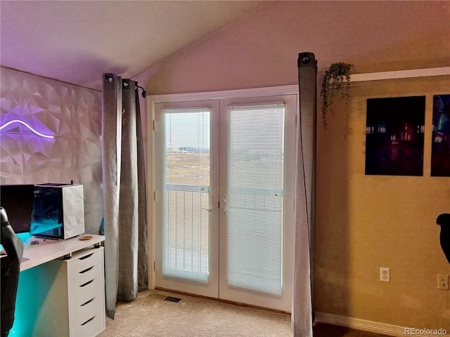 doorway to outside featuring lofted ceiling, light carpet, and visible vents