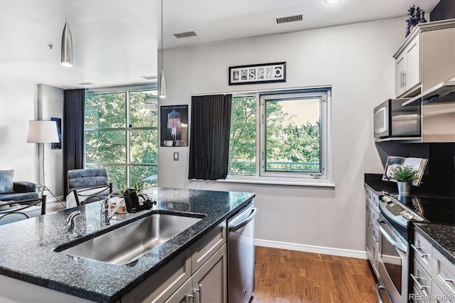 2958 Syracuse St Unit 214, Denver, CO 80238 - kitchen with visible vents, a sink, appliances with stainless steel finishes, and a kitchen island with sink
