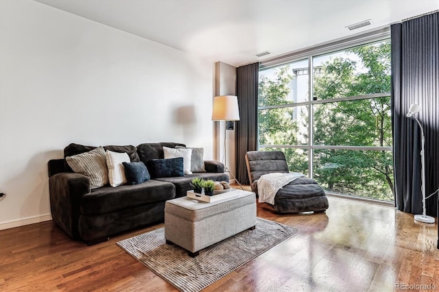 2958 Syracuse St Unit 214, Denver, CO 80238 - living area with a wall of windows, wood finished floors, and visible vents