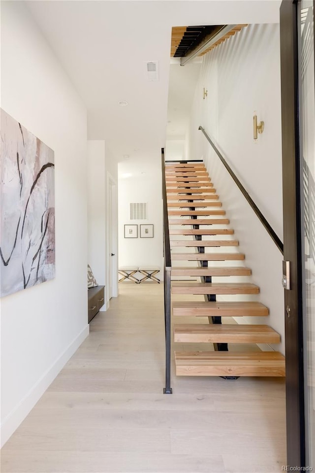 stairs featuring hardwood / wood-style flooring