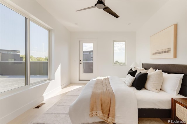 bedroom with multiple windows and ceiling fan