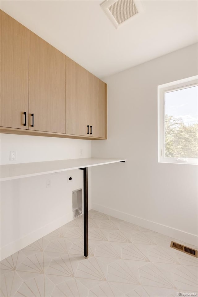 washroom with cabinets and electric dryer hookup