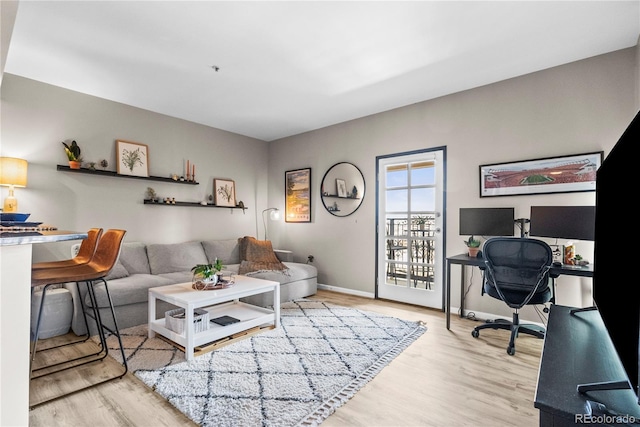 living area with wood finished floors and baseboards