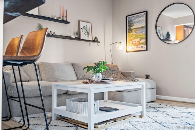 living room featuring baseboards and wood finished floors