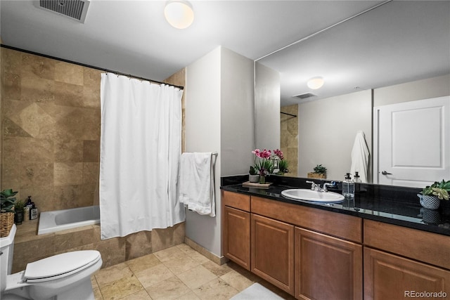 full bath featuring vanity, toilet, tiled shower / bath, and visible vents