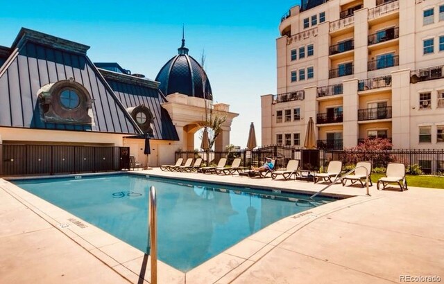 view of pool featuring a patio area and fence