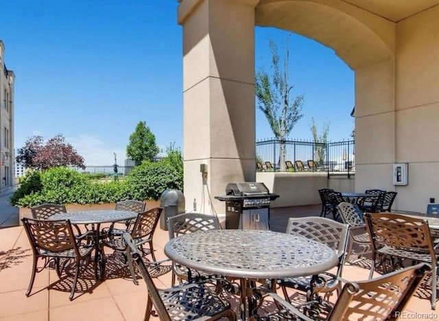 view of patio / terrace featuring outdoor dining area, area for grilling, and fence