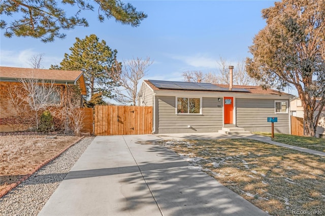 ranch-style house with solar panels