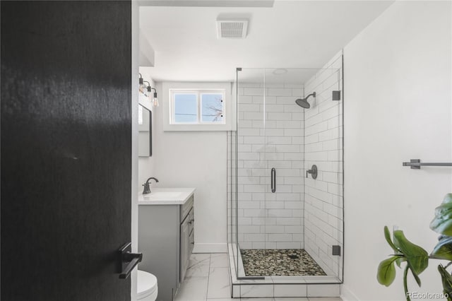 bathroom with vanity, a shower with shower door, and toilet