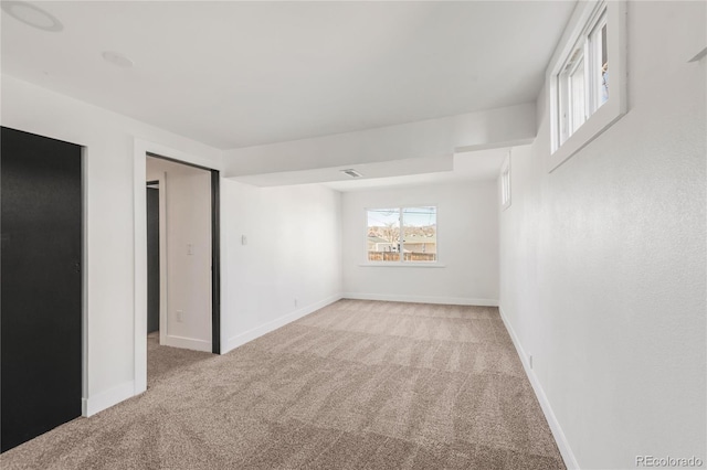 unfurnished room with light carpet