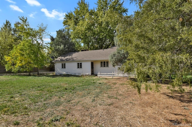 rear view of house with a yard