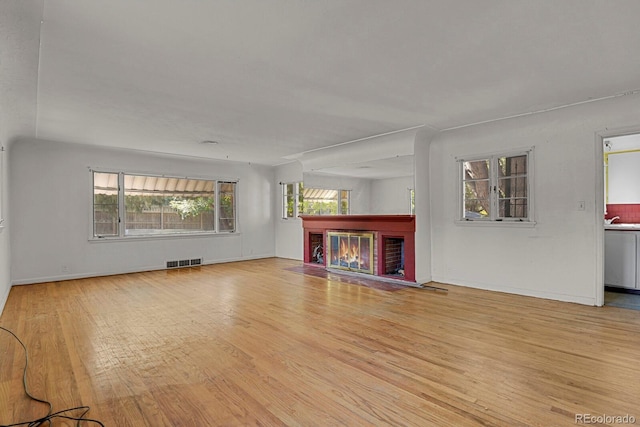 unfurnished living room featuring light hardwood / wood-style flooring