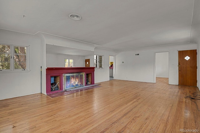 577 96th St, Louisville, CO 80027 - unfurnished living room featuring light wood-style floors and a brick fireplace