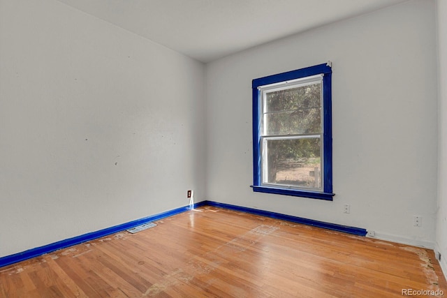 unfurnished room with hardwood / wood-style floors