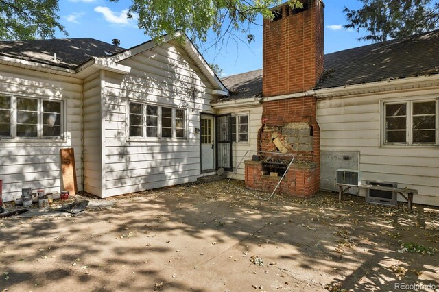 577 96th St, Louisville, CO 80027 - rear view of property with a chimney, a patio area, and roof with shingles