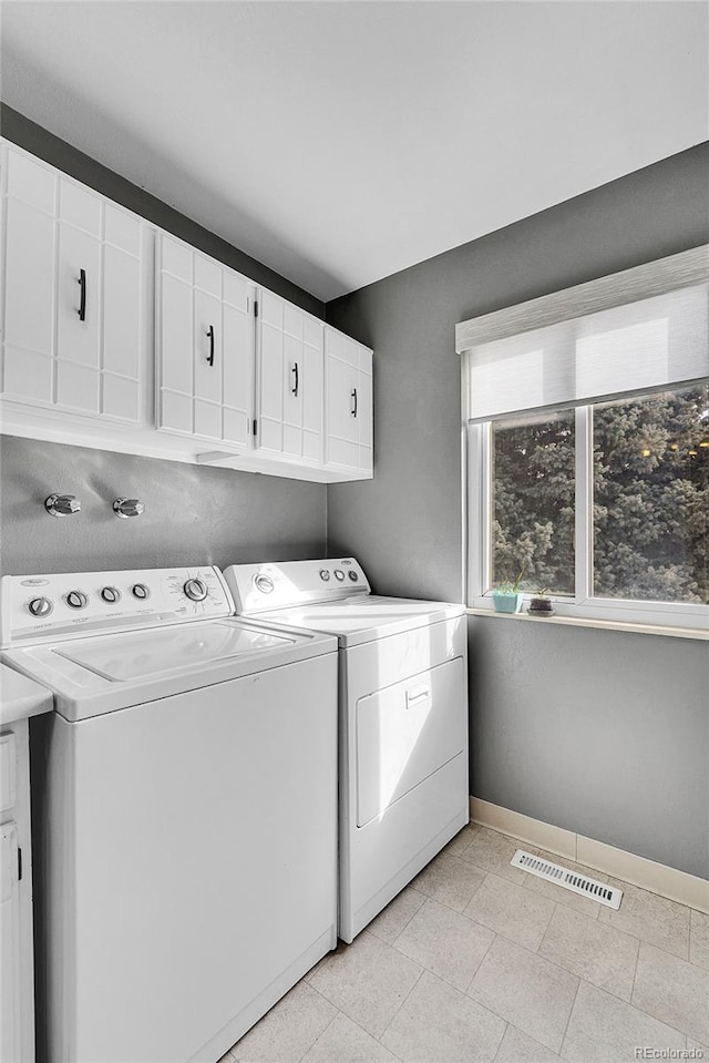 laundry area with cabinets and washer and dryer