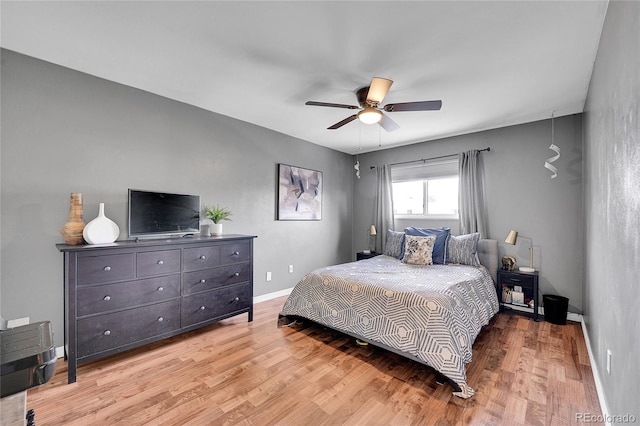 bedroom with ceiling fan and light hardwood / wood-style floors