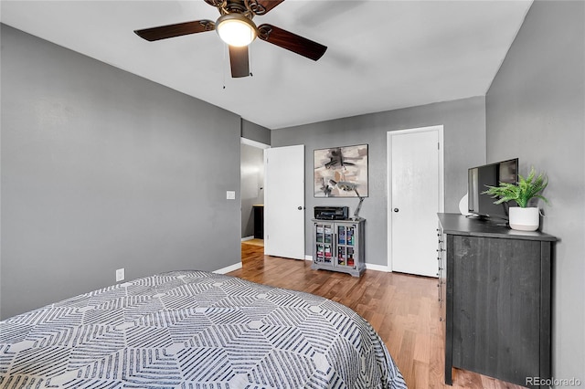 bedroom featuring hardwood / wood-style flooring and ceiling fan