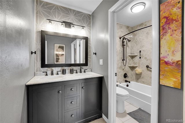 full bathroom featuring tiled shower / bath, vanity, tile patterned floors, and toilet