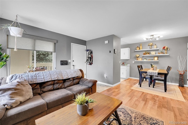 living room featuring light wood-style flooring and baseboards