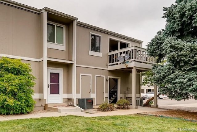 7973 Chase Cir Unit 56, Arvada, CO 80003 - back of property with a balcony, cooling unit, a yard, and stucco siding