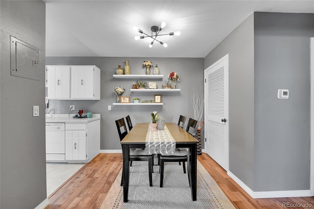7973 Chase Cir Unit 56, Arvada, CO 80003 - dining space with light wood-style flooring, a chandelier, baseboards, and electric panel