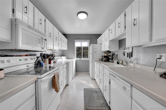 7973 Chase Cir Unit 56, Arvada, CO 80003 - kitchen with white appliances, a sink, baseboards, and white cabinets