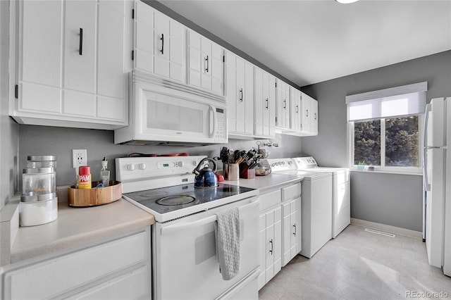 7973 Chase Cir Unit 56, Arvada, CO 80003 - kitchen featuring white appliances, separate washer and dryer, light countertops, white cabinetry, and baseboards